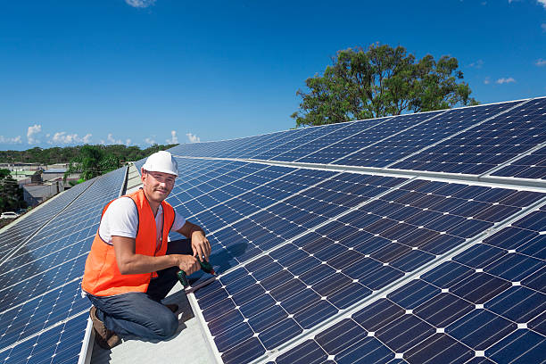 <span  class="uc_style_uc_tiles_grid_image_elementor_uc_items_attribute_title" style="color:#ffffff;">Young technician installing solar panels on factory roof</span>